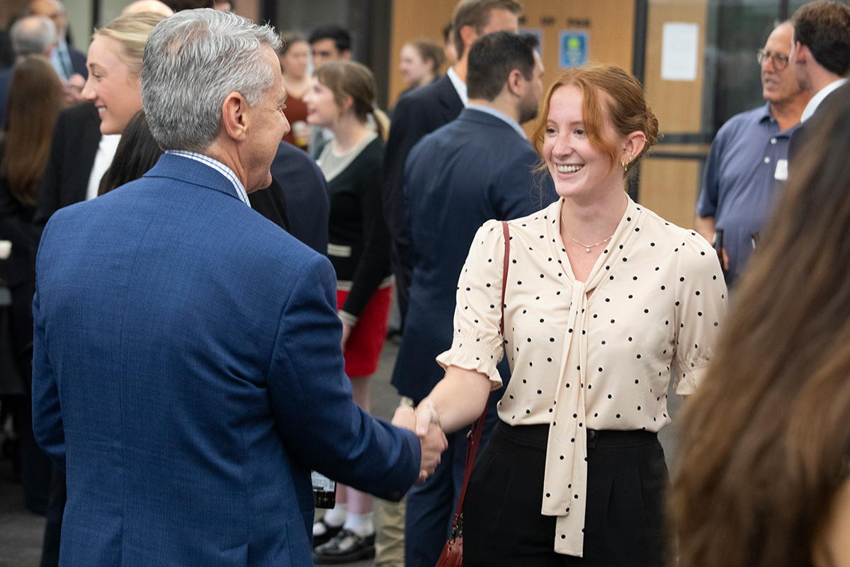 Woman shaking a man's hand in a conference